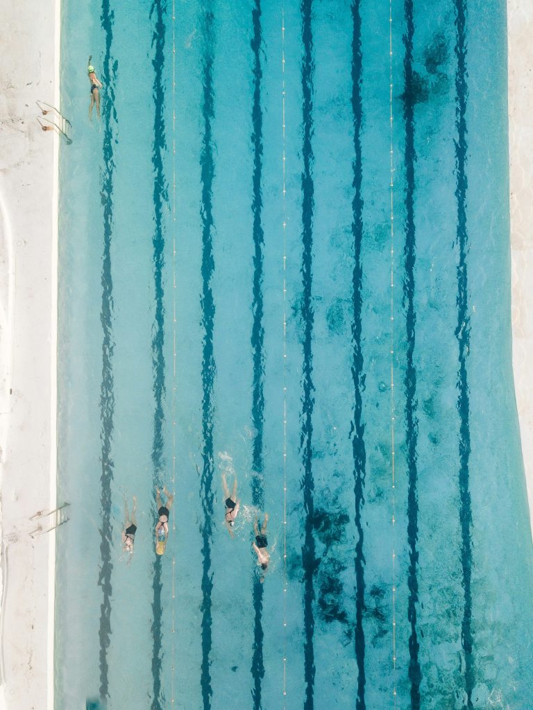 five people swimming on pool